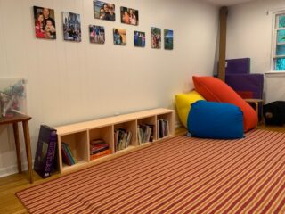 A family playroom with family pictures on the walls is neat and tidy-an organized life, ma