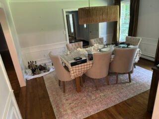 Spring declutttering: a dining room has dishes arranged for packing on the table.